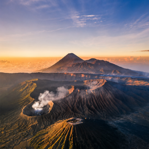 Smoke rising from Mount Bromo crater during sunrise