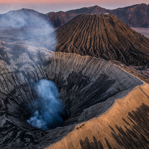Smoke rising from Mount Bromo crater during sunrise