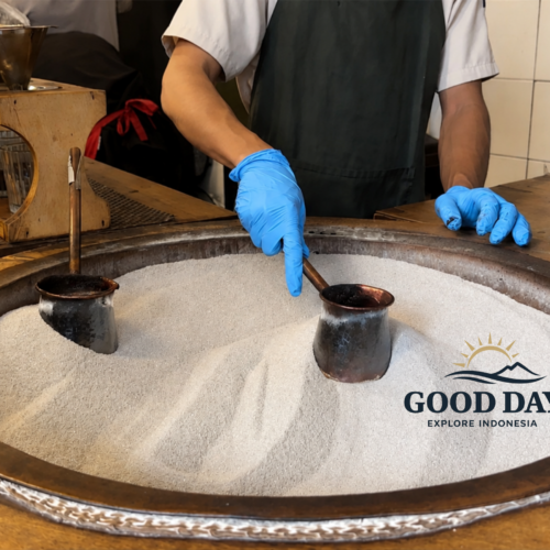 Traditional Indonesian coffee brewing process at a café in Glodok Jakarta, featuring coffee pots heated in hot sand and handcrafted manual brew techniques inside a vintage coffee shop.