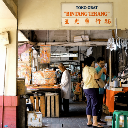 Traditional shop corridor in Glodok Chinatown Jakarta featuring local merchants, heritage storefronts, and shoppers exploring one of the city's oldest commercial districts.