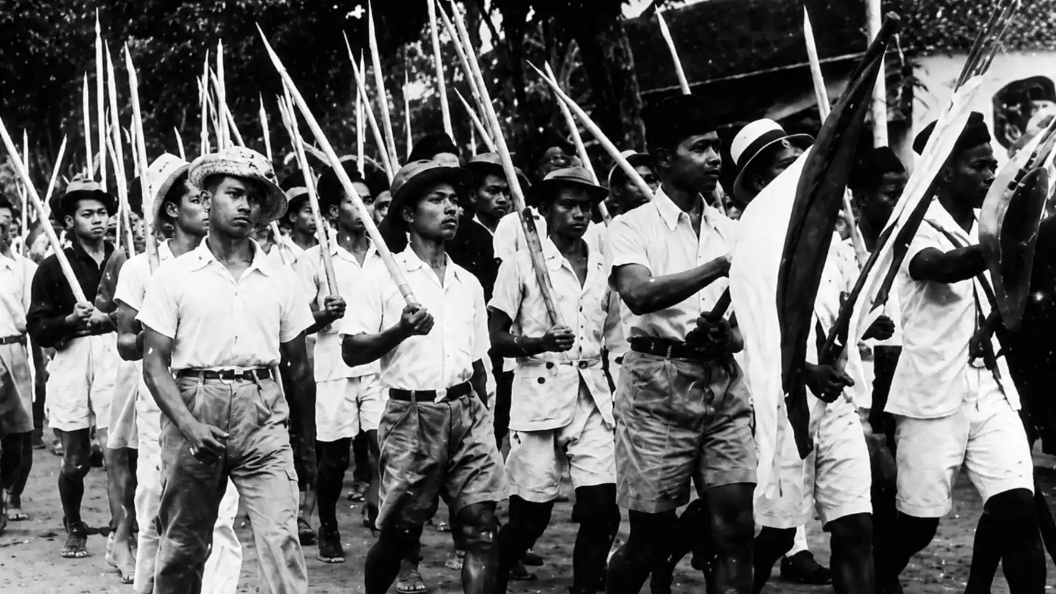 Indonesian freedom fighters carrying bamboo spears and traditional weapons during the Battle of Surabaya in November 1945, one of the most significant battles of the Indonesian National Revolution.