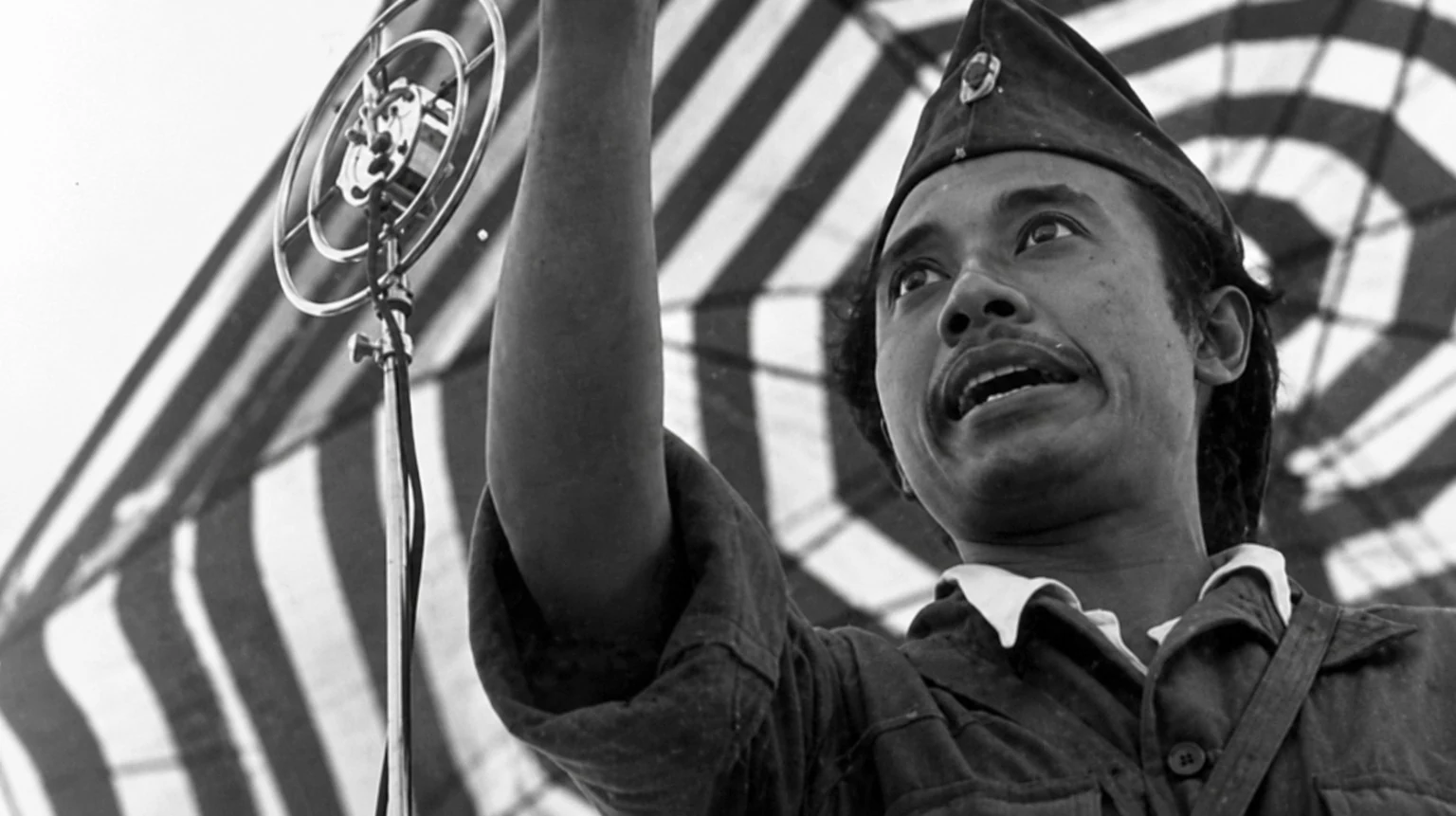 Historic photograph of Bung Tomo delivering his famous speech during the Battle of Surabaya on November 10, 1945, inspiring Indonesian resistance in the Indonesian National Revolution.