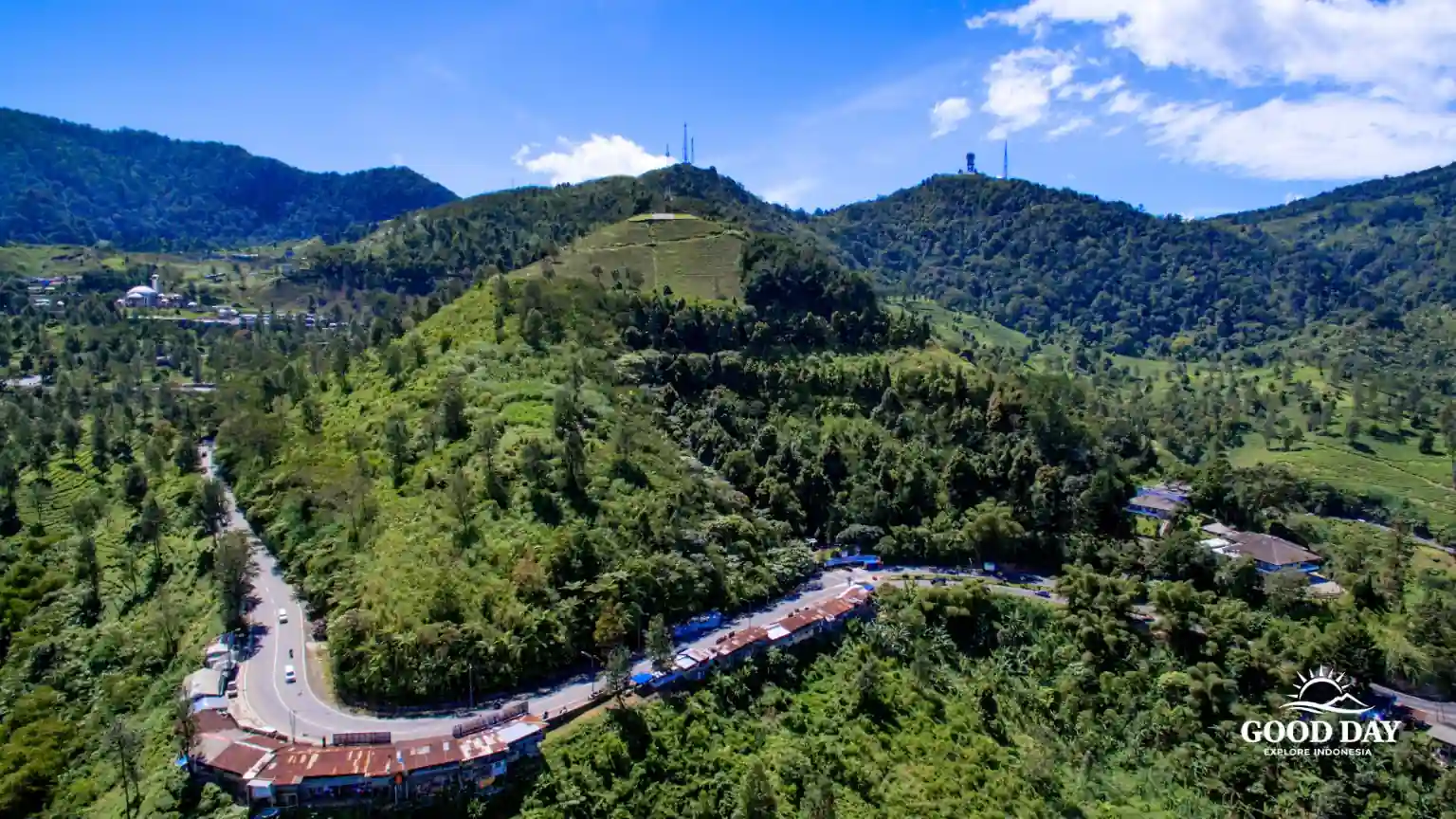 A panoramic view of the lush hills and tea plantations in Puncak, Bogor, West Java, Indonesia, one of the region's most popular mountain destinations.