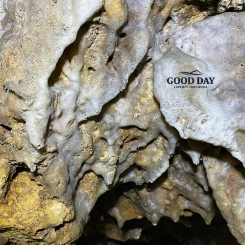 Close-up view of natural limestone cave formations inside Goa Macan Mati, Yogyakarta, Indonesia. Intricate stalactites and flowstone formations created over thousands of years are illuminated by cave exploration lighting, revealing unique textures, mineral deposits, and the hidden underground beauty of one of Jogja's most fascinating caves.