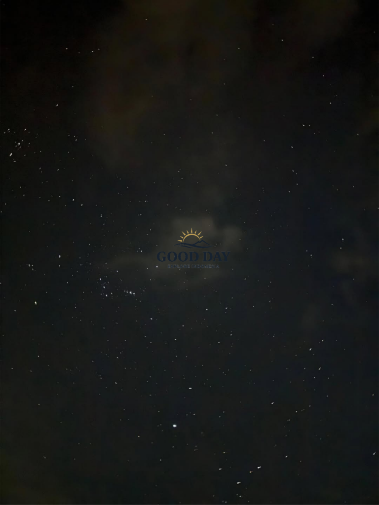 Star-filled night sky above Pulau Seribu, Indonesia, featuring countless visible stars scattered across a dark tropical sky with light clouds drifting through the celestial landscape.
