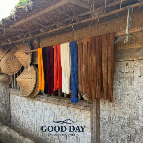 Colorful hand-dyed weaving threads drying outside a traditional Sasak house in Sade Village, Lombok, showcasing the island’s rich weaving heritage and authentic local culture.