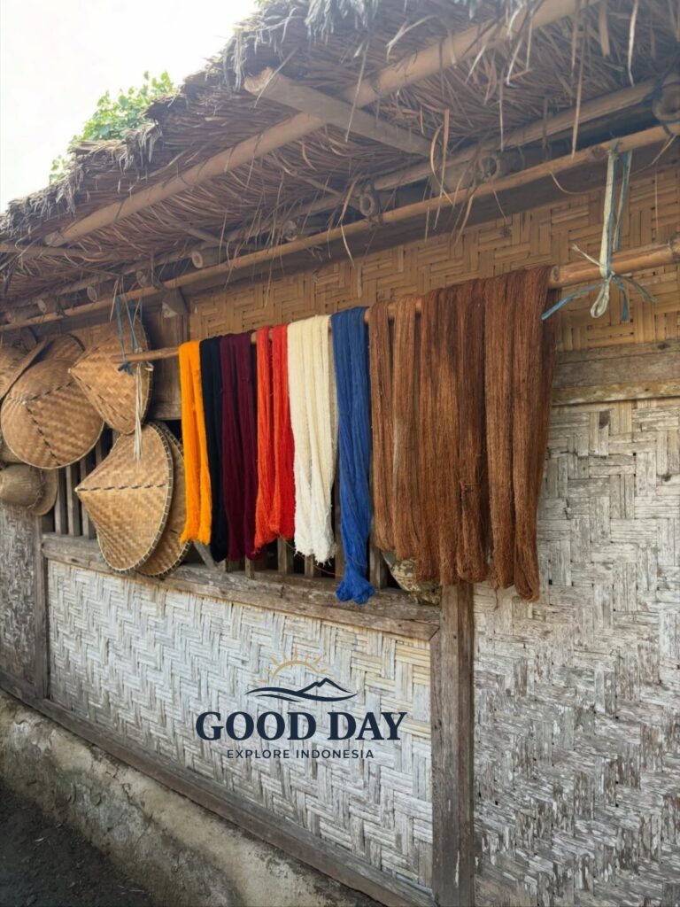 Colorful hand-dyed weaving threads drying outside a traditional Sasak house in Sade Village, Lombok, showcasing the island’s rich weaving heritage and authentic local culture.