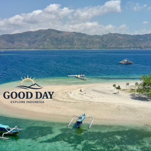 Aerial view of a pristine Gili island in Lombok featuring a white sandbar, crystal-clear turquoise waters, traditional Indonesian outrigger boats, and a tropical shoreline surrounded by the stunning coastline of Lombok.