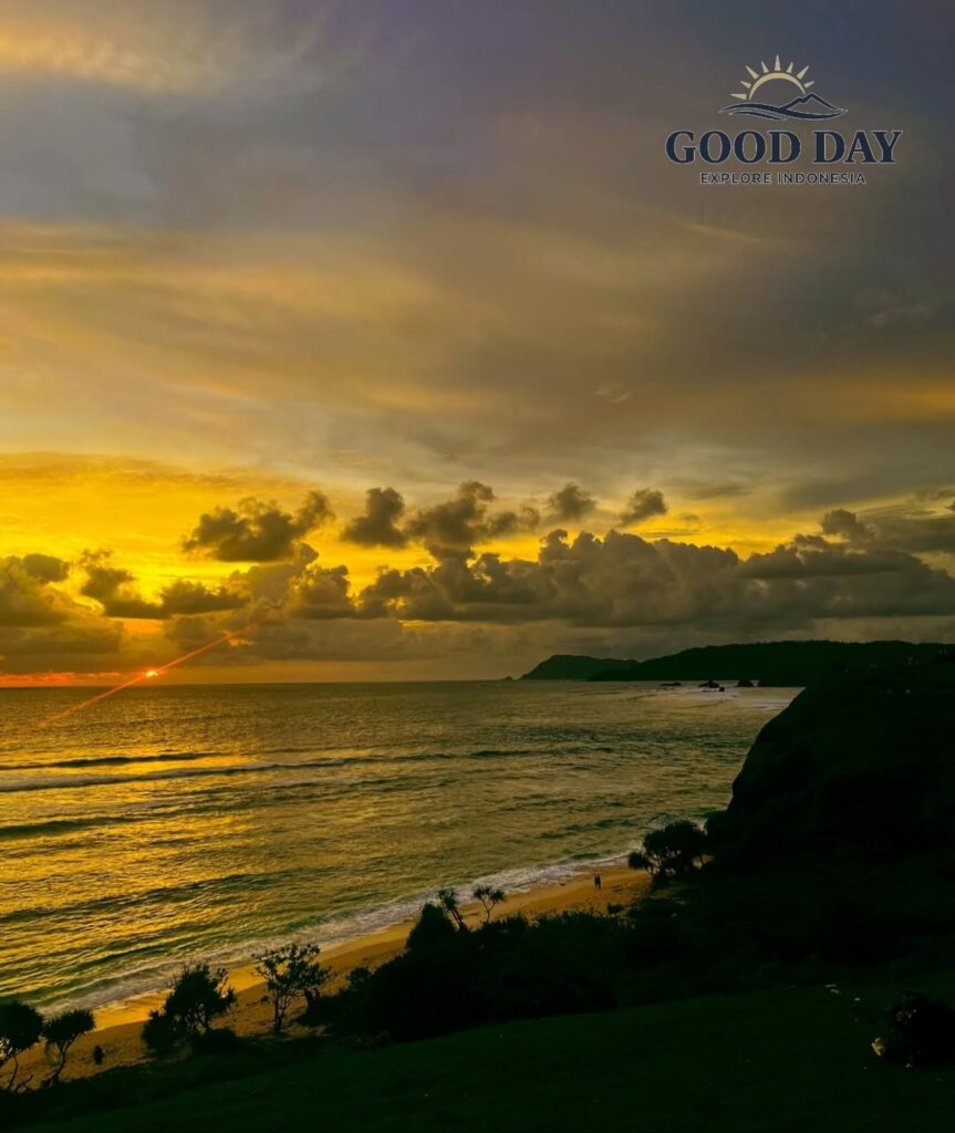 Sunset view from Merese Hill in Lombok, Indonesia, overlooking the Indian Ocean with golden sunlight reflecting on the waves, dramatic clouds, rugged coastal cliffs, and a pristine beach below.