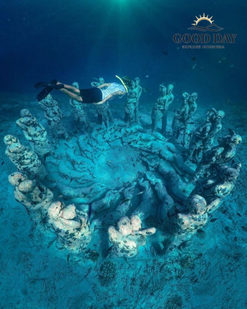 A snorkeler exploring the famous underwater statue installation in Lombok, Indonesia. Surrounded by crystal-clear blue water and tropical marine life, the submerged sculptures create one of Lombok’s most unique snorkeling and underwater photography attractions.