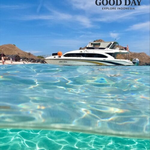 Luxury yacht anchored in the crystal-clear turquoise waters of Lombok, Indonesia, with stunning coastal hills and a tropical island backdrop. The transparent sea and vibrant blue sky create a picture-perfect paradise for island hopping, snorkeling, and luxury marine adventures.