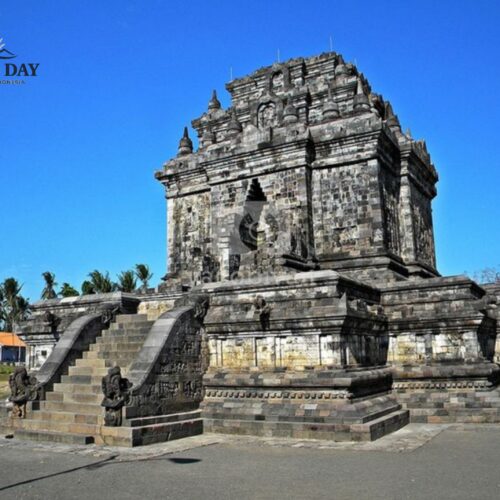 Candi Mendut, an ancient Buddhist temple in Magelang near Yogyakarta, Indonesia, featuring impressive stone architecture, detailed carvings, and a grand staircase under a clear blue sky. The historic temple is one of Central Java’s most important cultural and religious landmarks.