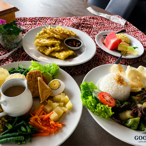 Traditional Indonesian cuisine served in Yogyakarta, featuring Gudeg, Nasi Campur, stir-fried beef with vegetables, fried snacks, fresh tropical fruits, and authentic Javanese dishes beautifully presented on a dining table.