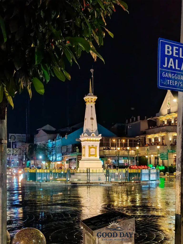 Tugu Yogyakarta illuminated at night in the heart of Yogyakarta, Indonesia, showcasing the city's iconic white monument surrounded by vibrant urban lights and historic streets.