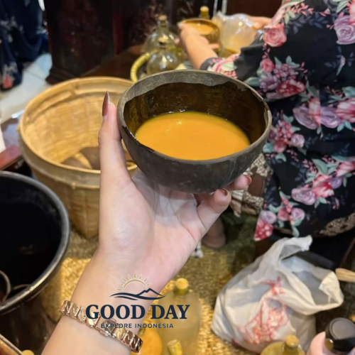 A traditional glass of Jamu, Indonesia's herbal wellness drink, being served at a local market in Yogyakarta, surrounded by handmade bottles of natural herbal beverages.