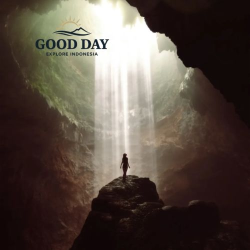 A traveler standing beneath the famous Heaven's Light inside Jomblang Cave, Yogyakarta, Indonesia, as powerful beams of sunlight pour through the cave opening and illuminate the massive underground chamber.