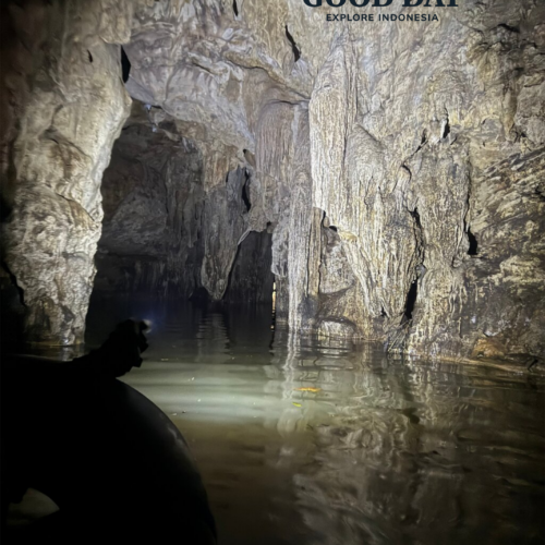 Ancient limestone formations and underground river passage inside Jomblang Cave, Yogyakarta, Indonesia, featuring stunning stalactites, reflective water, and a hidden cave exploration route.