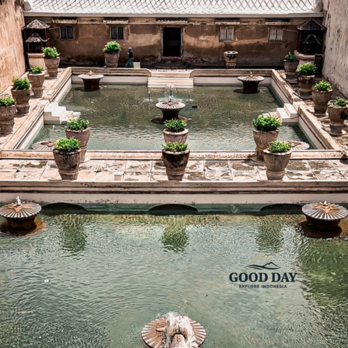 Aerial view of the historic bathing pools at Taman Sari Water Castle in Yogyakarta, Indonesia, featuring elegant fountains, tranquil water basins, and traditional Javanese royal architecture within the former palace complex.