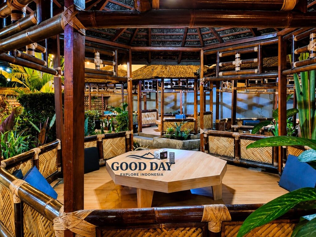 Traditional Sundanese restaurant in Bandung featuring private bamboo dining gazebos, wooden architecture, woven bamboo details, tropical plants, and a cozy open-air atmosphere.