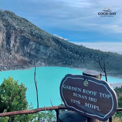 Panoramic view of Kawah Putih Bandung from Sunan Ibu Viewpoint, featuring a stunning turquoise volcanic crater lake surrounded by dramatic cliffs and lush mountain landscapes in Ciwidey, West Java.