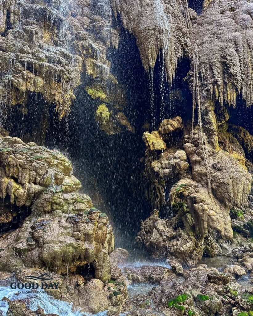 Detailed view of limestone formations inside Goa Tetes Lumajang with crystal-clear water droplets cascading over natural rock terraces, creating a stunning cave waterfall landscape in East Java, Indonesia.