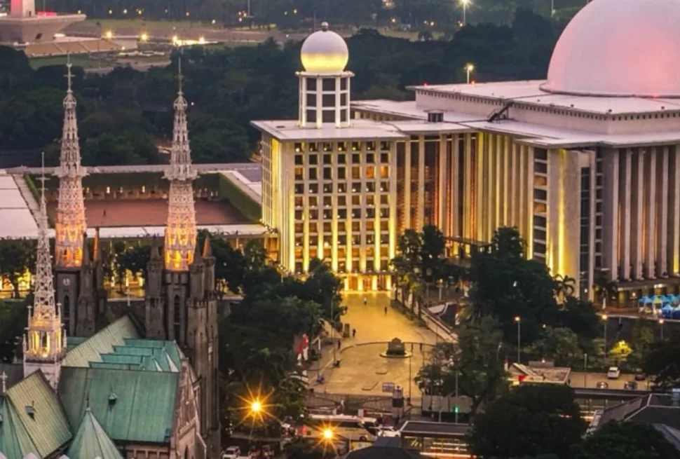 Aerial view of Istiqlal Mosque and Jakarta Cathedral standing opposite each other in Central Jakarta, Indonesia, symbolizing religious harmony and mutual respect.