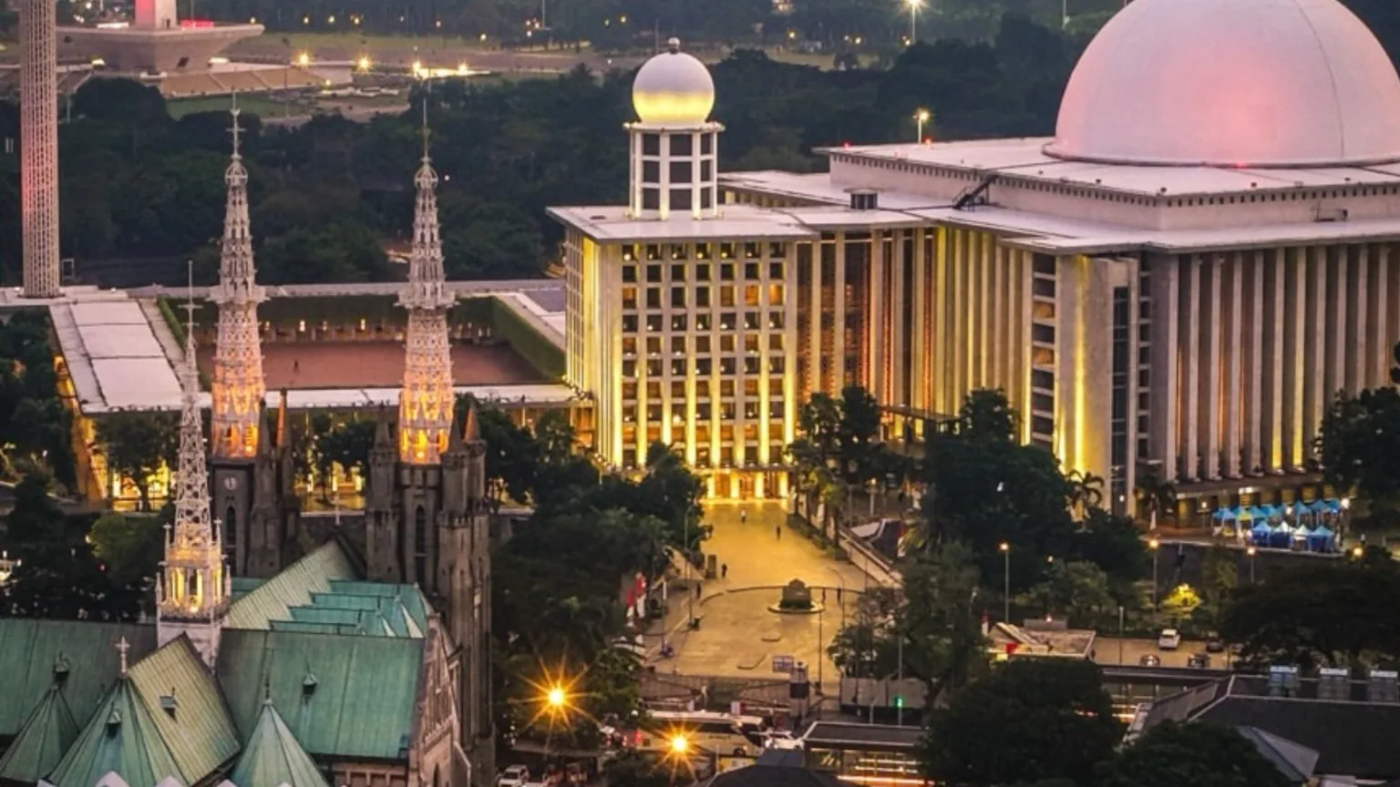 Aerial view of Istiqlal Mosque and Jakarta Cathedral standing opposite each other in Central Jakarta, Indonesia, symbolizing religious harmony and mutual respect.