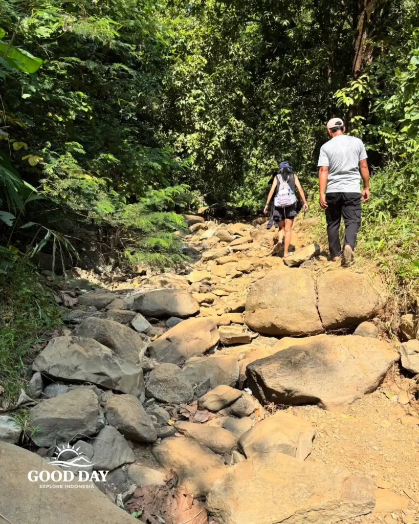 Travelers exploring Geopark Ciletuh in West Java on a one-day trip from Jakarta with Good Day Tour, featuring spectacular waterfalls, rainforest, cliffs, and UNESCO Global Geopark landscapes.