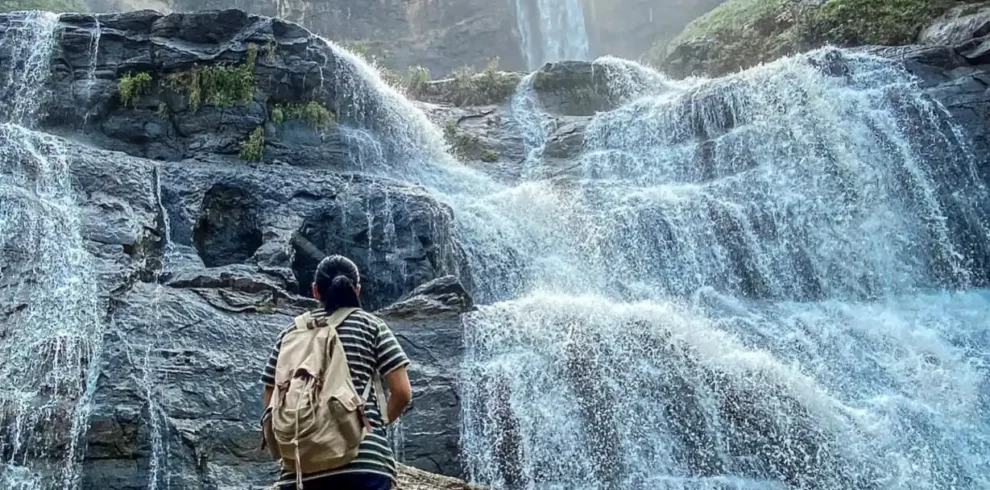 Travelers exploring Geopark Ciletuh in West Java on a one-day trip from Jakarta with Good Day Tour, featuring spectacular waterfalls, rainforest, cliffs, and UNESCO Global Geopark landscapes.